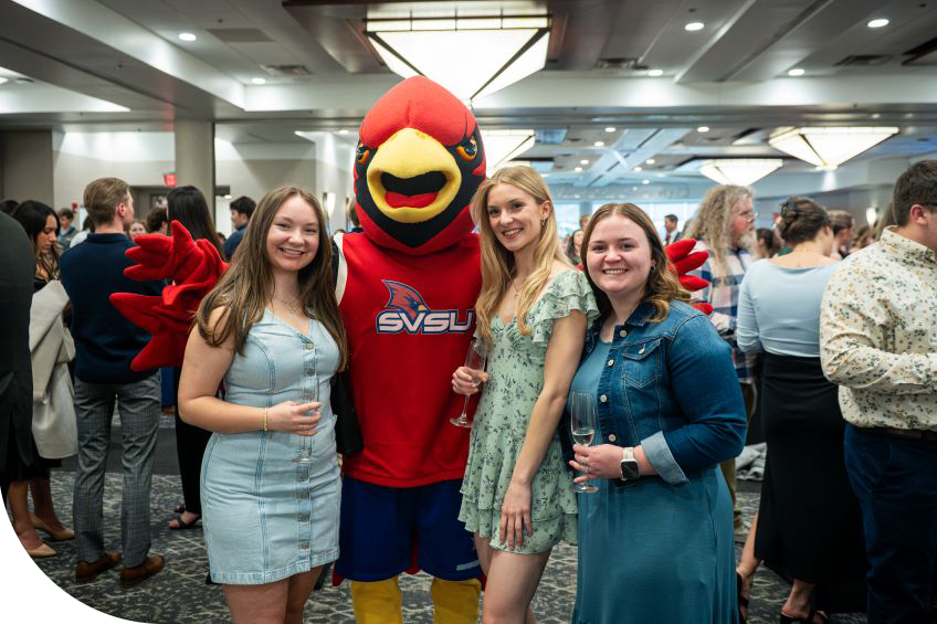 graduates celebrating with Coop at Senior Toast